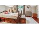 Charming bedroom featuring hardwood floors, a window, and a unique, wood-framed bed at 912 S Washington St, Denver, CO 80209