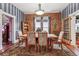 Inviting dining room showcasing a rustic brick wall, natural light, and a cozy atmosphere for gatherings at 912 S Washington St, Denver, CO 80209