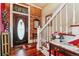 Inviting foyer with hardwood floors, exposed brick, and a classic staircase at 912 S Washington St, Denver, CO 80209