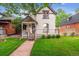 Charming home with a welcoming front porch and well-maintained lawn at 912 S Washington St, Denver, CO 80209