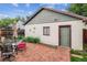 Detached garage with brick patio and a seating area offers additional outdoor space for relaxation at 912 S Washington St, Denver, CO 80209