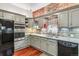 Lovely kitchen boasting gray cabinets, granite countertops, stainless appliances, and an exposed brick wall for added character at 912 S Washington St, Denver, CO 80209