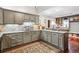 Well-appointed kitchen with gray cabinets, tile backsplash, and granite countertops offering a functional and attractive space at 912 S Washington St, Denver, CO 80209