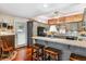 Well-appointed kitchen with brick accent, modern appliances, granite counters, and convenient breakfast bar seating at 912 S Washington St, Denver, CO 80209