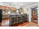Stylish kitchen with a brick accent wall, granite countertops, breakfast bar, and hardwood floors at 912 S Washington St, Denver, CO 80209