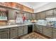 Beautiful kitchen with granite countertops, gray cabinets, stainless appliances, and exposed brick for a rustic touch at 912 S Washington St, Denver, CO 80209