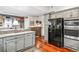 Open-concept kitchen featuring modern appliances, gray cabinets, and convenient access to the adjacent mudroom at 912 S Washington St, Denver, CO 80209