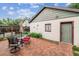 The backyard patio has red bricks and an outdoor dining set for outdoor relaxation at 912 S Washington St, Denver, CO 80209