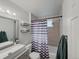 Cozy bathroom featuring a modern vanity, and shower with a stylish shower curtain at 30819 Hilltop Dr, Evergreen, CO 80439