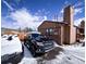 View of the exterior of the house, driveway, and chimney on a partly cloudy day at 30819 Hilltop Dr, Evergreen, CO 80439