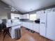 Well-lit kitchen with stainless steel appliances, white cabinetry, and breakfast bar with stools at 30819 Hilltop Dr, Evergreen, CO 80439