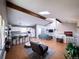 Bright living room with hardwood floors, skylight, white walls, and vaulted ceiling at 30819 Hilltop Dr, Evergreen, CO 80439