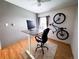 Functional office space with a standing desk, neutral colors, and a bike for convenience at 30819 Hilltop Dr, Evergreen, CO 80439