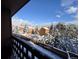 Picturesque view from the porch overlooking snow-covered trees and houses on a sunny day at 30819 Hilltop Dr, Evergreen, CO 80439