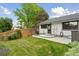 Well-maintained backyard featuring a patio, grill, wooden fence, and lush greenery at 8867 Yukon St # 49, Broomfield, CO 80021