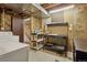 Unfinished basement has laundry area, workbench, and stairs to upper level at 8867 Yukon St # 49, Broomfield, CO 80021