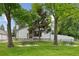 Charming home exterior with a lovely yard, mature trees, picnic tables, and a white picket fence at 8867 Yukon St # 49, Broomfield, CO 80021