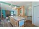 Open concept kitchen with granite island, custom cabinetry, and seamless flow to living area at 8867 Yukon St # 49, Broomfield, CO 80021