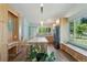 Modern kitchen with custom wood cabinetry, island seating, and a window bench overlooking the yard at 8867 Yukon St # 49, Broomfield, CO 80021