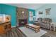 Cozy living room with stone fireplace, wood floors, plush seating, and natural light at 8867 Yukon St # 49, Broomfield, CO 80021