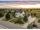 Panoramic aerial shot displays a gray two-story home with a well-kept lawn, mature trees, and surrounding neighborhood at 5397 Lenox Ct, Castle Rock, CO 80104