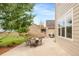 Concrete back patio featuring an outdoor dining table, grill, and firepit with a stone retaining wall at 5397 Lenox Ct, Castle Rock, CO 80104