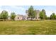 Spacious backyard with a well-maintained lawn, fire pit, and mature trees, offering a serene outdoor retreat at 5397 Lenox Ct, Castle Rock, CO 80104