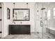 Stylish bathroom featuring a spacious glass shower, dark vanity, herringbone tile floor, and modern pendant lighting at 5397 Lenox Ct, Castle Rock, CO 80104