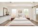 Cozy bedroom featuring a low platform bed, soft rug, modern decor, and sliding barn door to the bathroom at 5397 Lenox Ct, Castle Rock, CO 80104