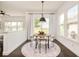Charming dining area with a round table, pendant lighting, and large windows overlooking the yard at 5397 Lenox Ct, Castle Rock, CO 80104