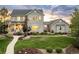 Attractive two-story home showcasing manicured lawn, mulched flower beds, and neutral gray facade on a partly cloudy day at 5397 Lenox Ct, Castle Rock, CO 80104
