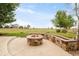 A stone fire pit with a retaining wall sitting on a large grassy lot in the backyard at 5397 Lenox Ct, Castle Rock, CO 80104