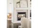 Close up view of a fireplace with a tiled surround, flanked by built-in shelving and comfortable seating at 5397 Lenox Ct, Castle Rock, CO 80104