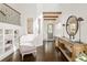 Elegant foyer with dark wood floors, a staircase, and a decorative table showcasing a mirror and accent lamps at 5397 Lenox Ct, Castle Rock, CO 80104