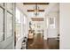 Bright foyer featuring dark hardwood floors, wood beam ceilings, an elegant light fixture, and large picture windows at 5397 Lenox Ct, Castle Rock, CO 80104