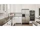Close-up of a kitchen with stainless steel appliances, white cabinets, and dark countertops at 5397 Lenox Ct, Castle Rock, CO 80104