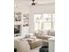 Bright living room with built-in shelves, ceiling fan, and comfortable neutral-toned furniture at 5397 Lenox Ct, Castle Rock, CO 80104