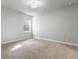 An empty bedroom with carpet floors and a window bringing in natural light at 10000 E 59Th Dr, Denver, CO 80238