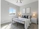 Neutral bedroom with lots of natural light, black metal bed frame, and matching end tables at 10000 E 59Th Dr, Denver, CO 80238