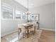 Bright dining area features hardwood floors, neutral paint, and modern chandelier at 10000 E 59Th Dr, Denver, CO 80238