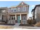 Charming two-story home with a welcoming front porch and a bright blue front door at 10000 E 59Th Dr, Denver, CO 80238