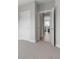 Hallway featuring neutral paint, white trim, and carpet floors at 10000 E 59Th Dr, Denver, CO 80238