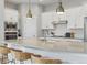 Close-up of a modern kitchen with white cabinets, stainless appliances, and a sleek countertop at 10000 E 59Th Dr, Denver, CO 80238