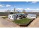 Well-maintained backyard featuring a deck, fenced garden area, and detached garage at 17445 County Road 6, Brighton, CO 80603