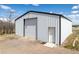 White barn with metal siding and roll-up door, providing ample storage space at 17445 County Road 6, Brighton, CO 80603