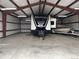 Large barn interior with ample room for storing vehicles and equipment, offering versatile use at 17445 County Road 6, Brighton, CO 80603
