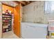 Unfinished basement area with storage shelves and freezer, offering ample space at 17445 County Road 6, Brighton, CO 80603
