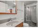 Bathroom with a sink and vanity, medicine cabinet, toilet, and glass shower enclosure at 17445 County Road 6, Brighton, CO 80603