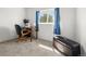 Bedroom with a desk and chair by the window, along with a storage ottoman at 17445 County Road 6, Brighton, CO 80603
