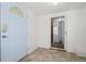 Entryway with tiled floor, white front door, and a glass-paned storm door leading inside at 17445 County Road 6, Brighton, CO 80603